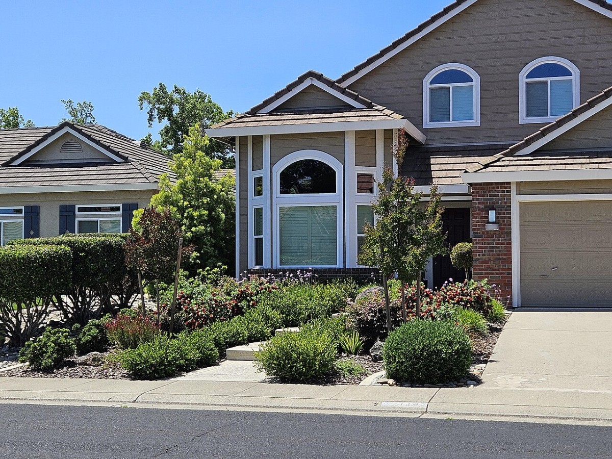 Water-wise residential landscape with layered xeric plant groupings